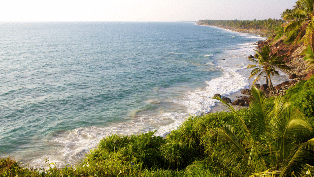 Varkala's cliff-lined coast with the Arabian Sea and colorful cafes on the cliffs.