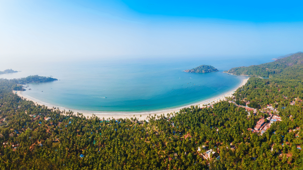 Aerial view of Palolem Beach, a crescent-shaped gem in the top 10 best South Goa beaches, known for its calm waters and scenic charm.