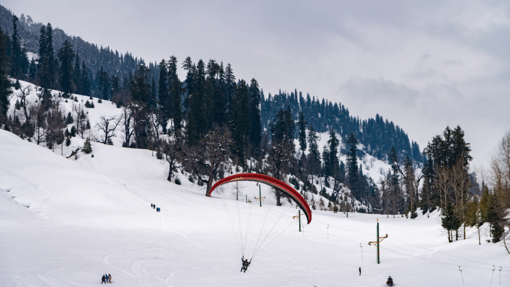 15 Best Places to Visit in Manali A paraglider soaring over the scenic Solang Valley, the top adventure destination and a must-visit place in Manali