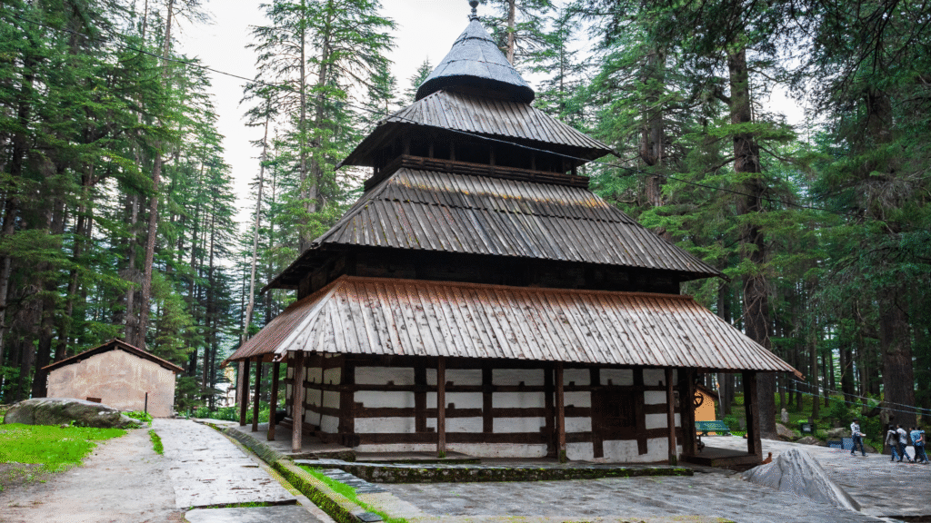 The unique wooden architecture of the ancient Hadimba Devi Temple surrounded by a cedar forest, a famous cultural place to visit in Manali.