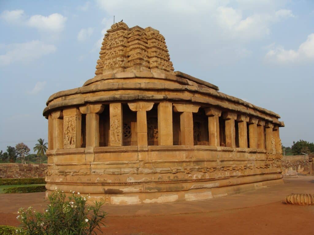 Durga Temple in Aihole glowing at sunrise, showcasing its semi-circular apsidal design and intricate carvings. Top 12 Must-Visit Temples in Aihole